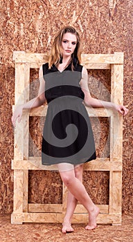 Full length Beautiful woman fashion style posing on wooden wall