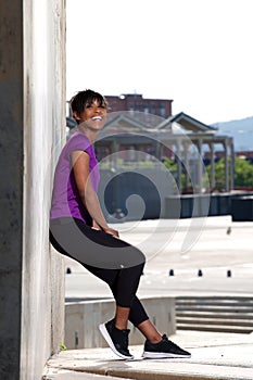 Full length beautiful young woman standing outdoors resting after work out