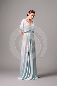 Full-length blue bridesmaid dress with flutter sleeves. Effortless festive summer look. Ginger lady