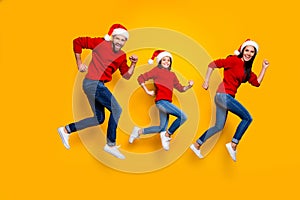 Full length body size of crazy smiling joyful happy family running for festive goods discounted wearing jeans denim red