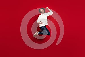 Full length body size photo of crazy aged man jumping high lucky lottery winner isolated on red color background