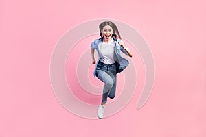 Full length body size photo of crazy girl jumping high running fast on sale isolated on pastel pink color background