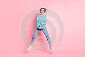 Full length body size photo girl childish careless jumping up isolated pastel pink color background