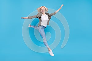 Full length body size photo happy woman jumping up stretching isolated pastel blue color background