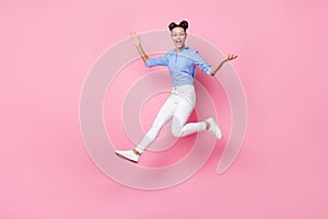 Full length body size photo of jumping crazy girl wearing casual clothes laughing isolated on pastel pink color