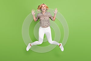 Full length body size photo of jumping woman careless happy isolated on bright green color background