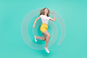 Full length body size photo schoolgirl jumping up running for sale isolated vibrant teal color background