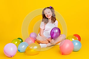 Full length body size photo schoolgirl at party with balloons smiling happy isolated vibrant yellow color background