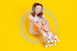 Full length body size photo schoolgirl wearing rollers smiling cheerful happy isolated bright yellow color background