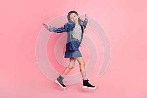 Full length body size photo smiling girl jumping up playful careless  pastel pink color background