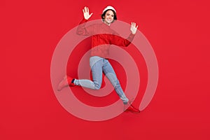 Full length body size photo woman in headwear jumping waving hand on meeting isolated vivid red color background