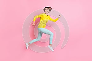 Full length body size photo of woman jumping high running fast looking back isolated on pastel pink color background