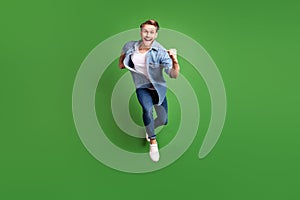 Full length body size photo of young guy jumping up running on sale isolated bright green color background