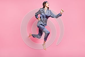Full length body size side profile photo of girl wearing nightwear jumping running on pajama party isolated on pastel