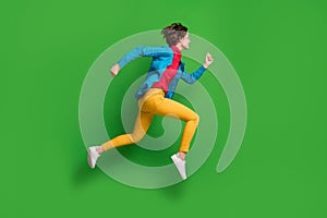 Full length body size side profile photo of jumping running girl in colorful clothes  on vibrant green color