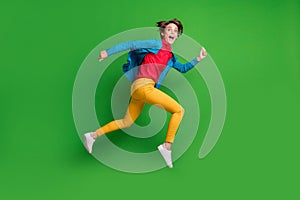 Full length body size side profile photo of jumping running girl shouting loudly in glasses isolated on bright green