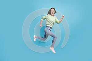 Full length body size side profile photo of laughing young girl running fast hurrying up jumping high smiling happily