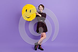 Full length body size view of attractive cheerful amazed girl holding yellow sticker isolated over bright violet purple