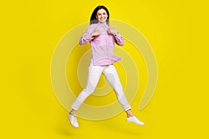 Full length body size view of attractive cheery girl jumping showing two thumbup ad isolated over bright yellow color