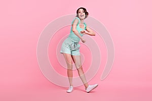 Full length body size view of attractive ecstatic cheerful girl dancing having fun clubbing isolated over pink pastel