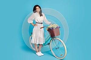 Full length body size view of attractive elegant cheerful girl with bike free spare time rest isolated over bright blue