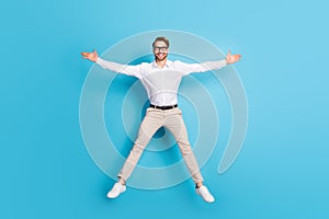Full length body size view of attractive successful cheerful man jumping like star isolated over bright blue color photo