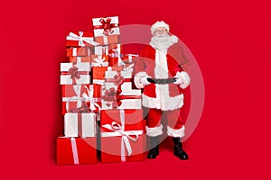 Full length body size view of his he handsome content fat cheery Santa pile stack gifts newyear shop store center mall