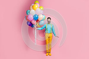 Full length body size view of his he nice attractive cheerful cheery glad bearded guy holding in hands helium air balls photo