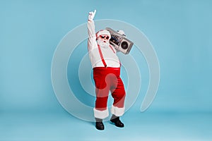 Full length body size view of his he nice cool stylish cheerful Santa big belly pants carrying vintage cassette player