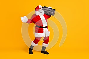 Full length body size view of his he nice funny positive thick white-haired Santa dj mc carrying cassette tape boombox