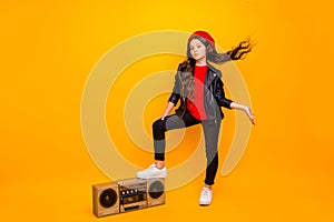 Full length body size view of nice attractive confident long-haired girl in streetstyle holding leg on boombox throwing