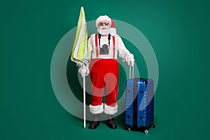 Full length body size view of nice handsome bearded funky cheerful overweight fat Santa carrying parasol valise air