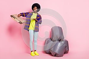 Full length body size view of pretty cheerful girl holding cardboard waste save planet earth solution isolated over pink