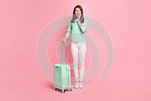 Full length body size view of pretty cheery amazed girl traveler with valise good news reaction isolated over pink