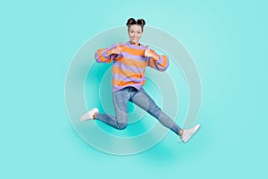 Full length body size view of pretty trendy cheerful girl jumping showing thumbup cool isolated over bright teal