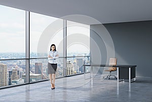 Full-length of brunette business lady in a workplace at modern corner panoramic office in New York, Manhattan. A concept of