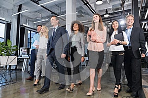 Full Length Business People Team Walking In Modern Office, Confident Businessmen And Businesswomen In Suits Diverse With