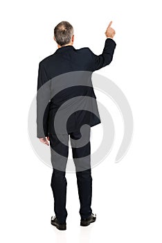 Full length businessman pointing upwards