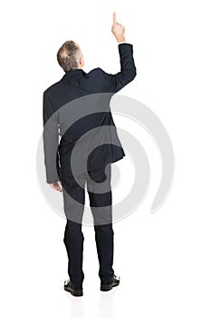 Full length businessman pointing upwards