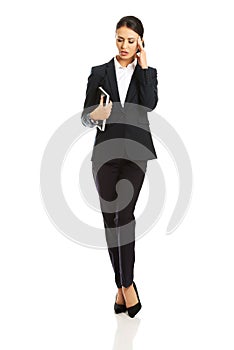 Full length businesswoman holding her notes