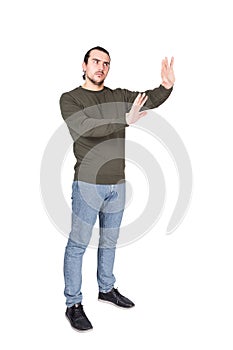 Full length of cautious man showing stop gesture with his palms, arms outstretched as deny or refuse, gesturing prohibition, no photo