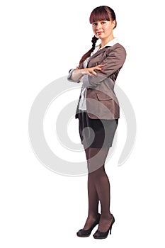 Full length of cheerful business woman standing with arms folded