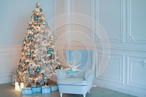 Full-length Christmas decoration of a New Year tree next to a sofa for relaxing