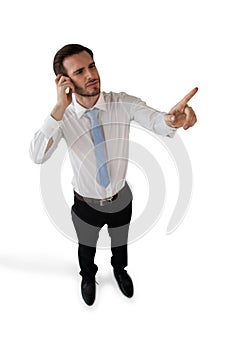 Full length of confused businessman touching invisible interface