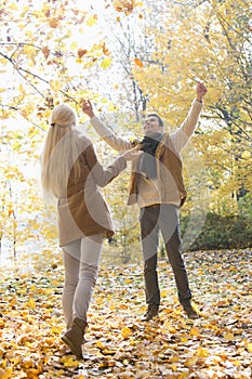 Full length of couple enjoying in autumn