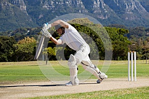 Full length of cricketer playing on field