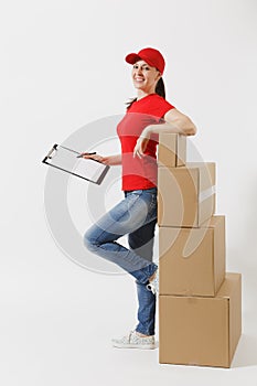 Full length of delivery woman in red cap, t-shirt isolated on white background. Female courier holding clipboard with