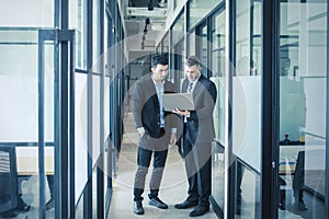 Full length diverse business people using laptop