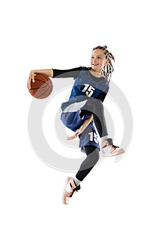 Full-length dynamic studio shot of young girl, basketball player in blue uniform training isolated over white studio