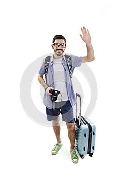 Full length of excited man traveling with luggage and camera